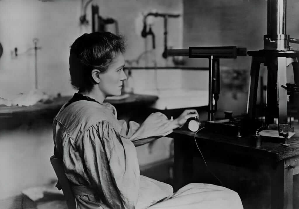 Marie Curie sitting in lab